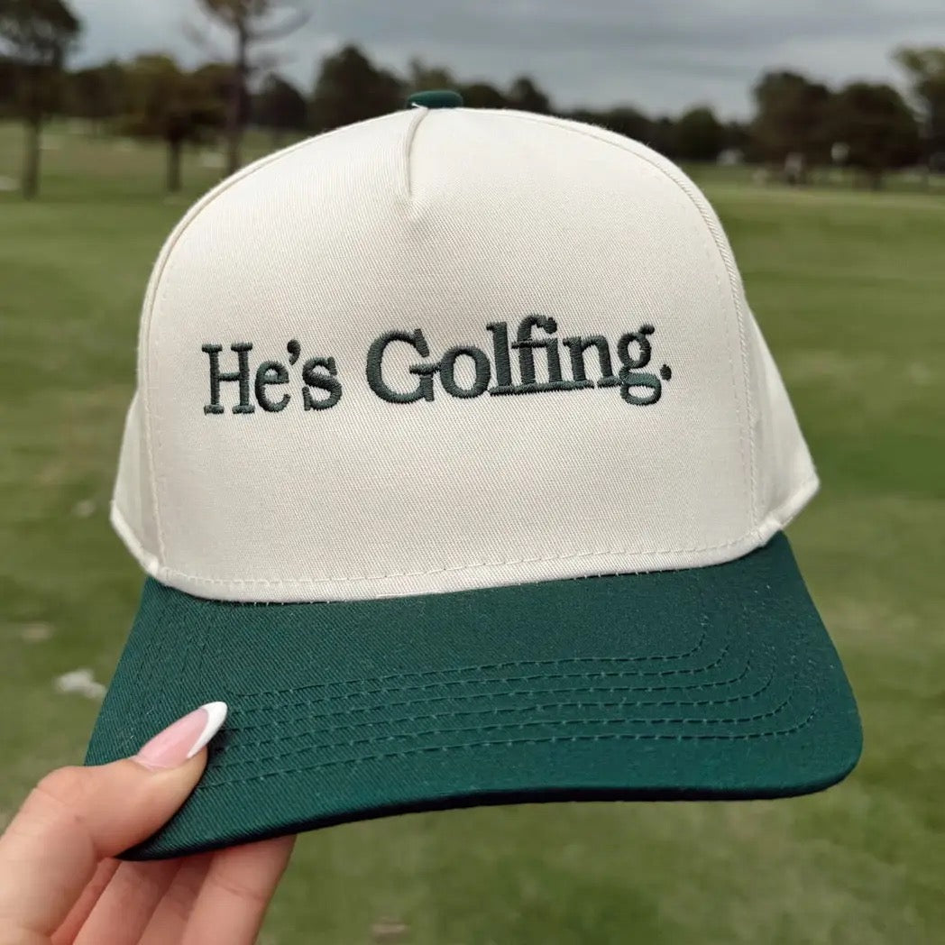 He's Golfing Green Vintage Trucker Hat